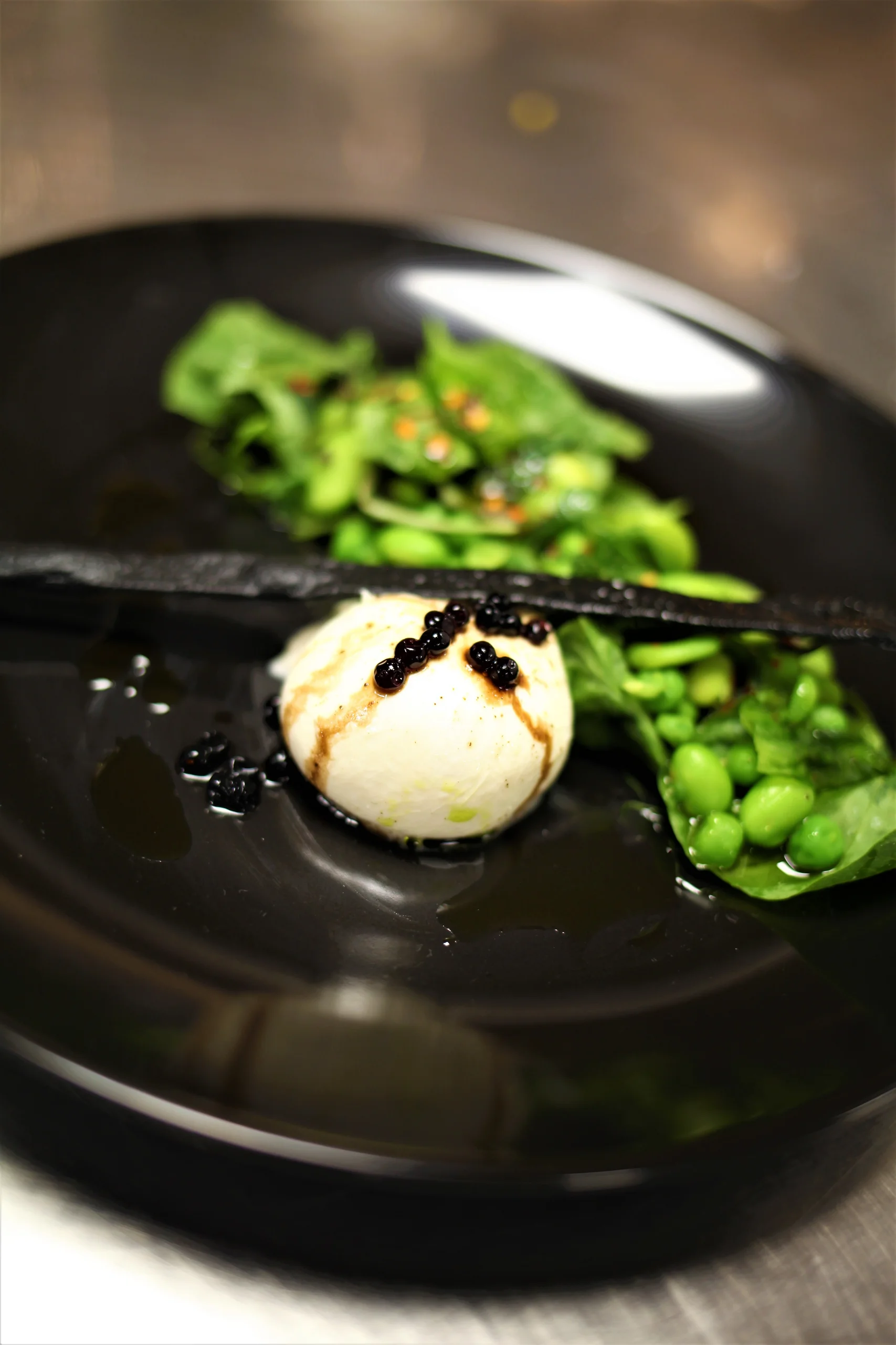 Seared scallop with saffron emulsion and microgreens